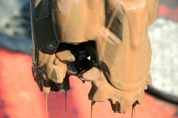 Photo of a drill bit with water based drilling mud on it.