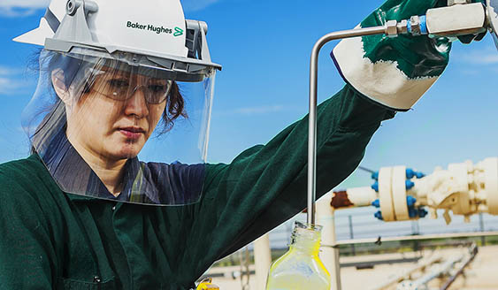 Photo of a Baker Hughes chemical engineer working in the field.