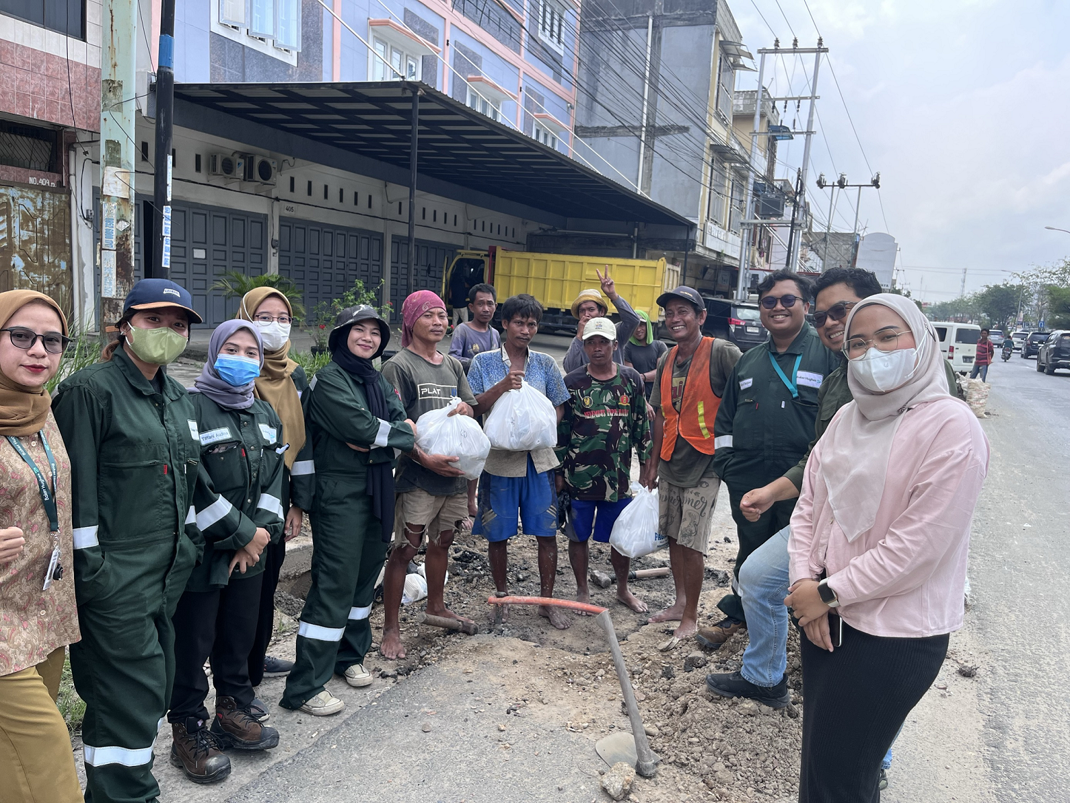 Team handing food in street 