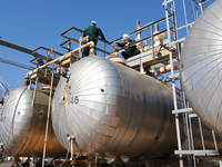 Photo of two Baker Hughes engineers at a refinery