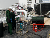 Photo of two Baker Hughes engineers at a refinery.