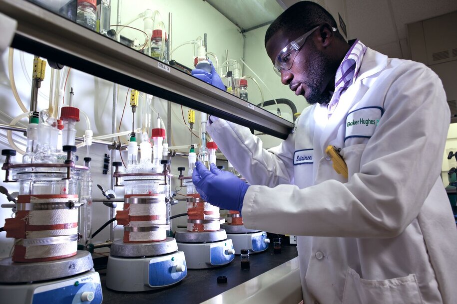 Baker Hughes corrosion lab technician working on process chemicals