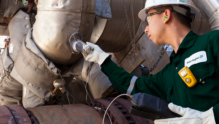 Photo of a person doing testing at a refinery.