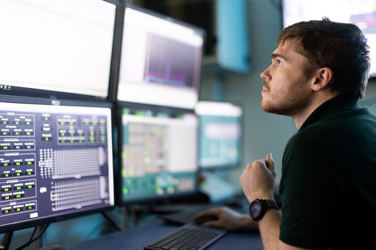 Worker at monitors