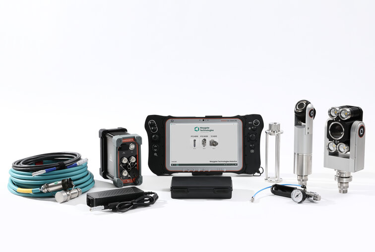 Industrial remote visual inspection (RVI) equipment set displayed on a white background, featuring a handheld device with a screen, inspection cables, connectors, and specialized tools used in nuclear power plant inspections and other industrial applications.