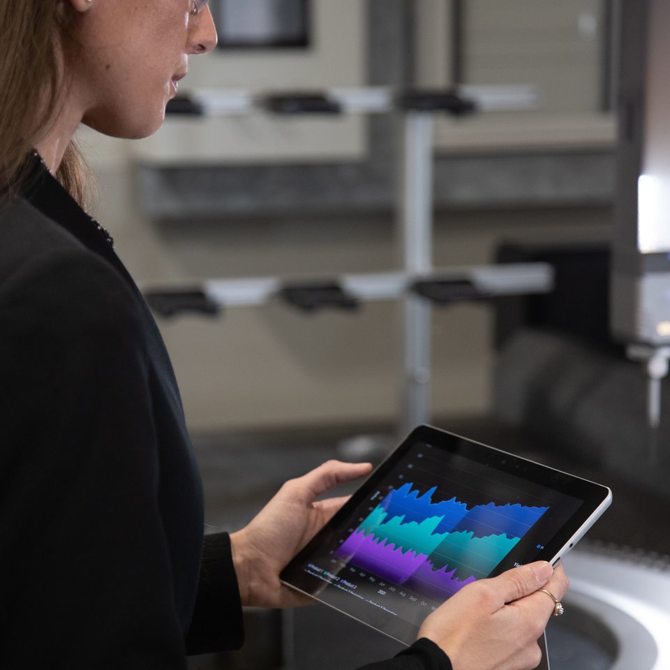 Woman looking at graph on tablet