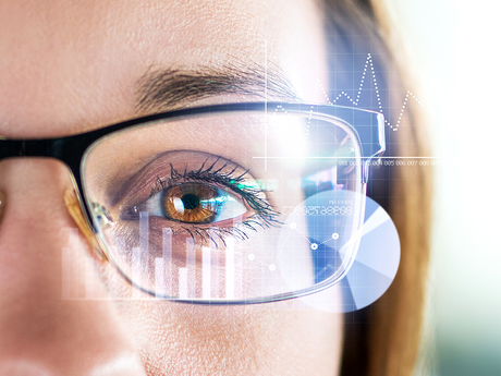 Woman with glasses looking at data.