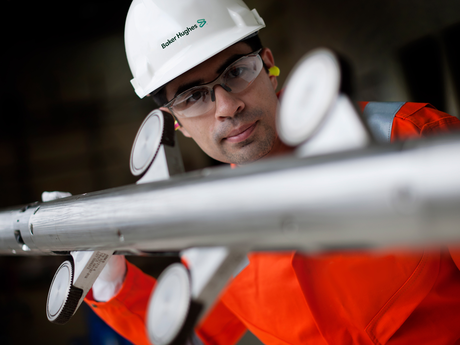 A Baker Hughes engineer inspecting a PowerTrac tool.