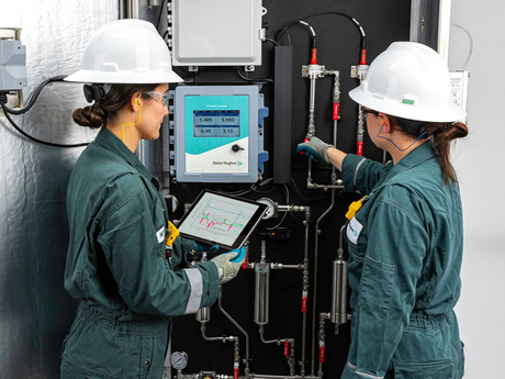 Two Baker Hughes employees deploying TOPGUARD in the field.