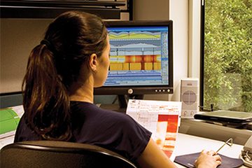 Photo of a reservoir engineer studying wireline log.