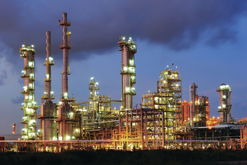 Photo of a refinery at night.