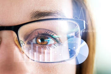 Woman with glasses looking at data.