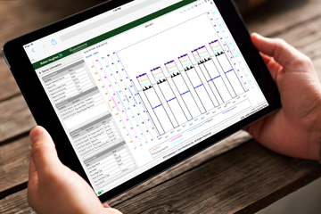 Photo of someone holding an iPad using the ProductionLink integrated production optimization platform software.