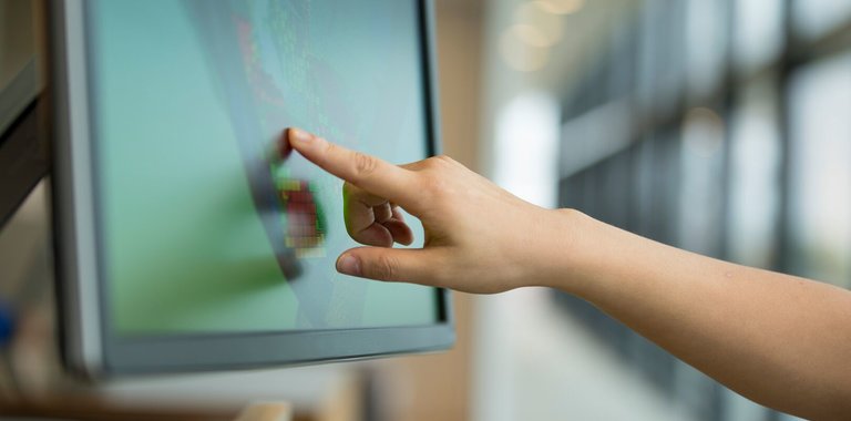a person pointing at a screen conducting remote services