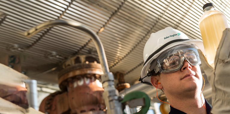 Photo of a Baker Hughes chemical engineer in the field.