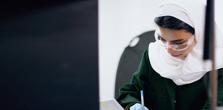Woman in safety glasses working