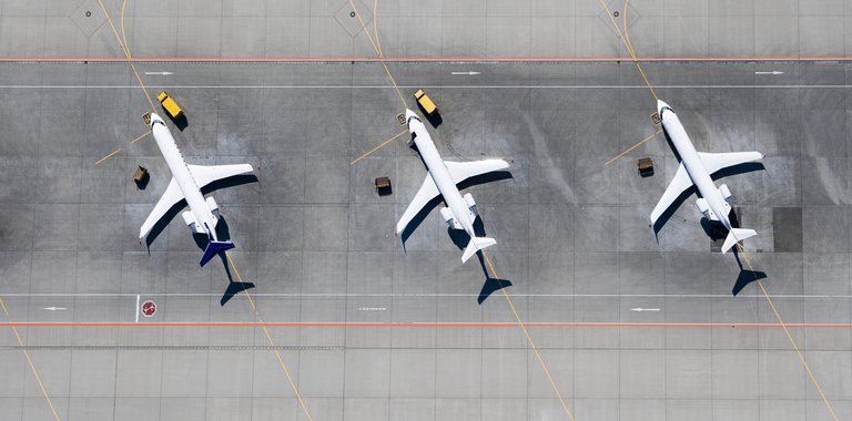 three airplanes lined up to be inspected