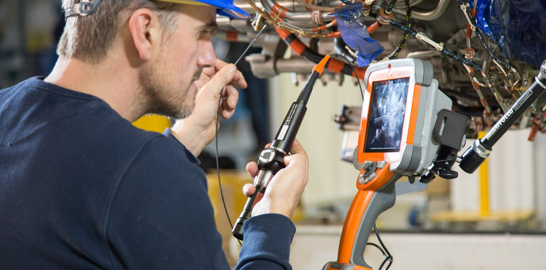 MViQ video borescope being used during routine inspection of an engine.