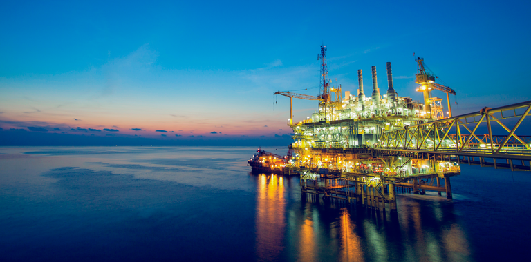 Photo of oil rig at sunset.