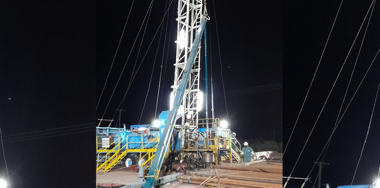 Photo of an oil rig at night.