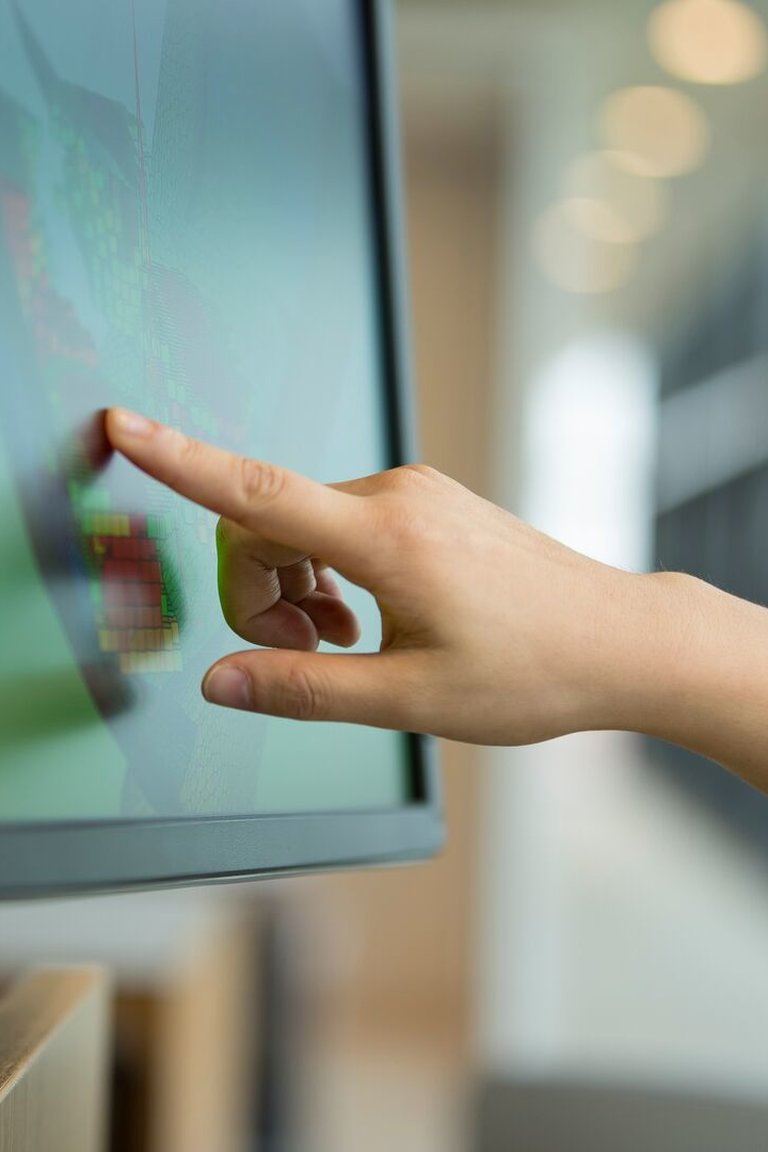 a person pointing at a screen conducting remote services
