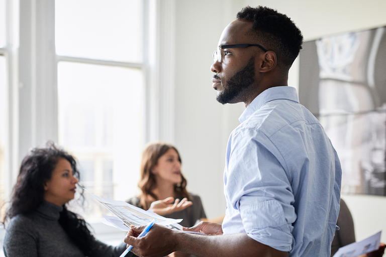 Male standing up during collaboration session with colleagues